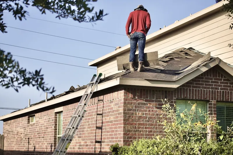 Professional roofer working on a residential roof in Flagtown